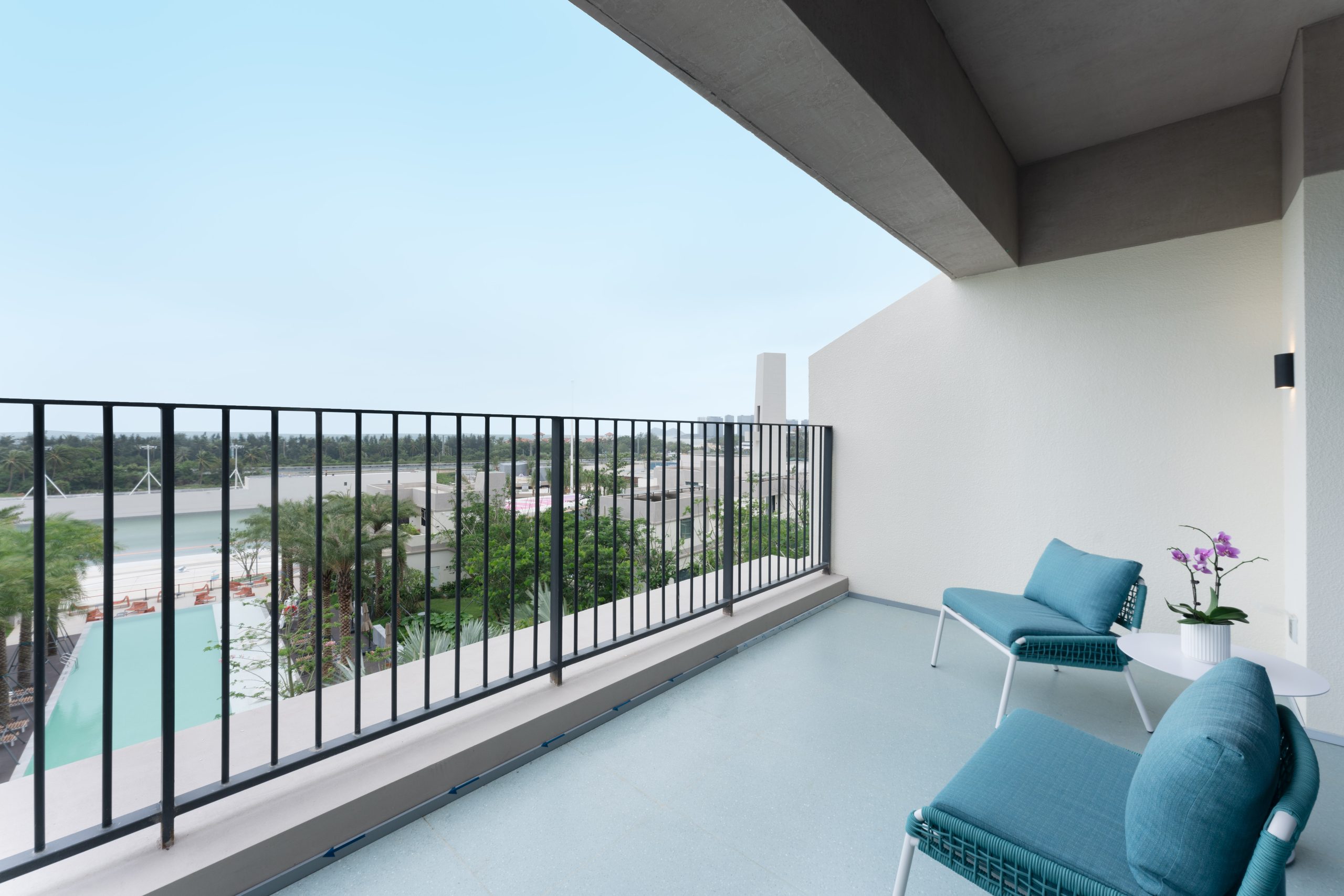 Private balcony of a Garden View room at UECHAO Hotel Riyuebay overlooking the tropical resort gardens, Riyue Bay, Wanning, Hainan
